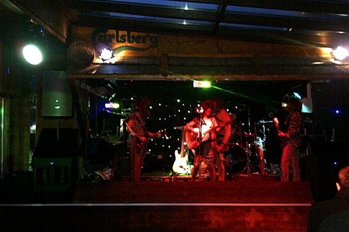 Group dressed in stone age constumes playing at Farinet