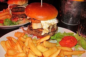 Close up of a double burger and fries