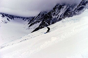 A person is skiing down a snow covered slope