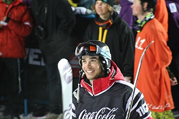 A man wearing a coca cola jersey smiles for the camera