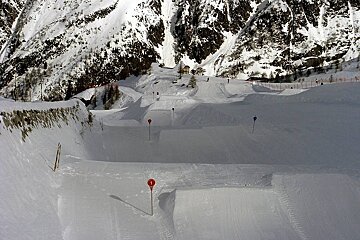 A snowy area with a red sign in the middle