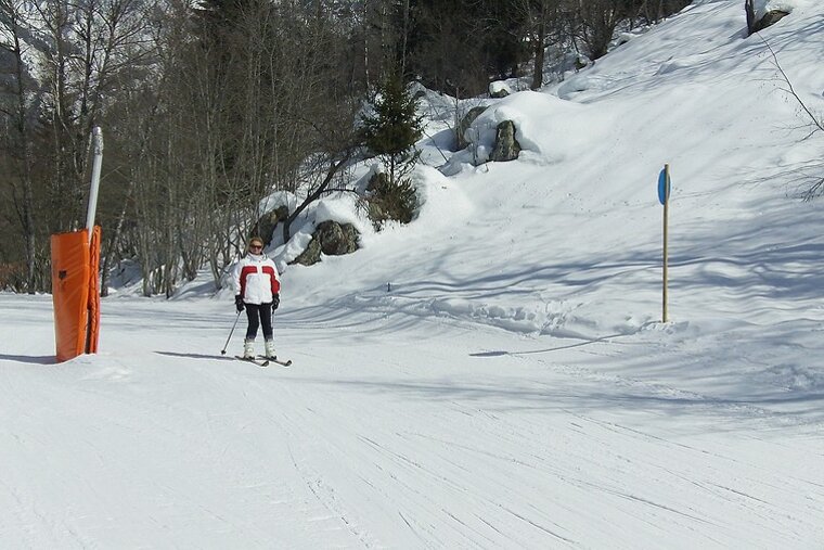 A person is skiing down a snow covered slope