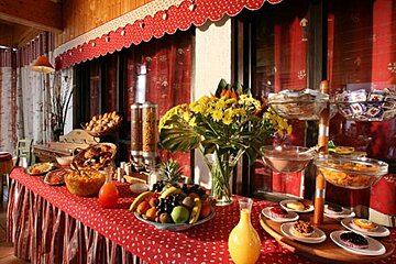 A buffet table with a vase of flowers on it
