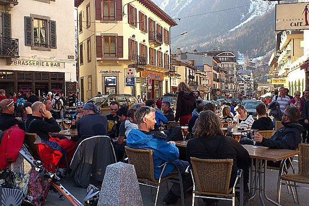 An image of skiers and snowboarders having apres-ski drinks outside bars in Chamonix Mont Blanc
