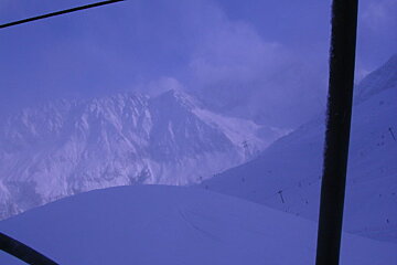 A view of a snowy mountain from a ski lift