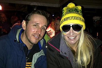A man and a woman wearing sunglasses and a hat that says australia