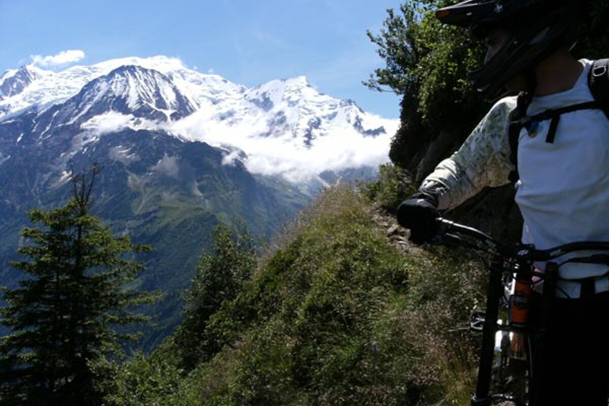 A person on a bike with a mountain in the background