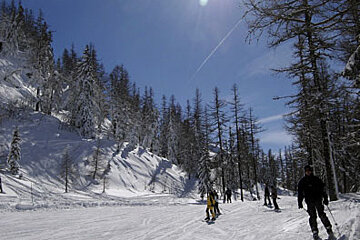A group of people skiing down a snow covered slope