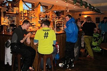 Men in ski gear at a bar