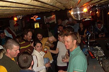 A castrol sign hangs above a crowd of people