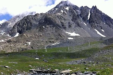 an image of a mountain and some ski lifts in summer