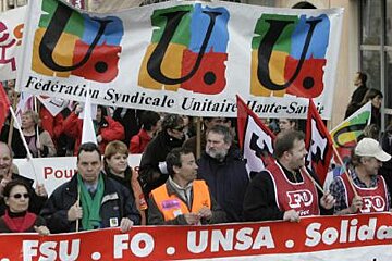 A group of people holding a banner that says u.u