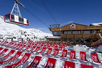 An image of the terrace and cable car at Restaurant Les Verdons, Courchevel 1850
