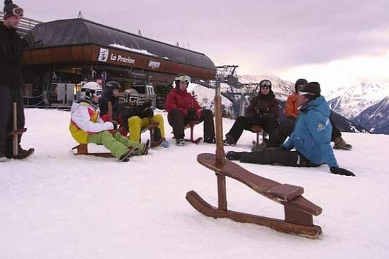 An image of people sledging in the snow