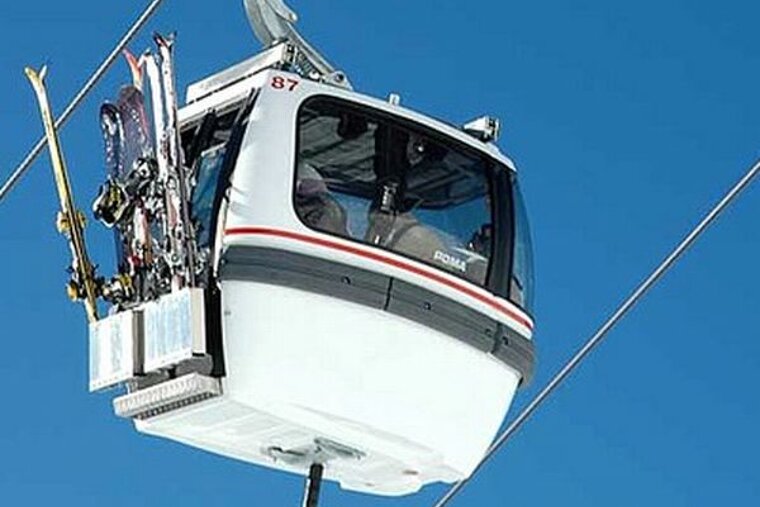 A ski lift with skis hanging from the side of it
