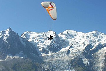 An image of a paraglider flying past Mont Blanc on a parapente