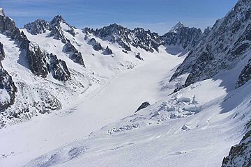 A snowy mountain range with a blue sky in the background