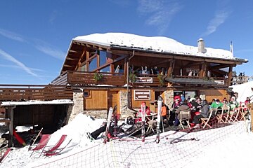 A snowy building with a sign that says restaurant bar