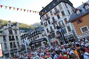 A crowd of people are gathered in front of a salomon sign