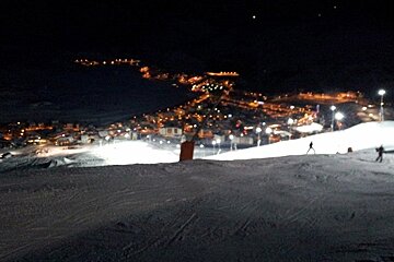 Town of Alpe d'Huez lit up and viewd from night skiing piste