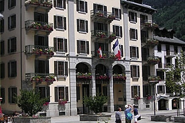 A group of people standing in front of a large building