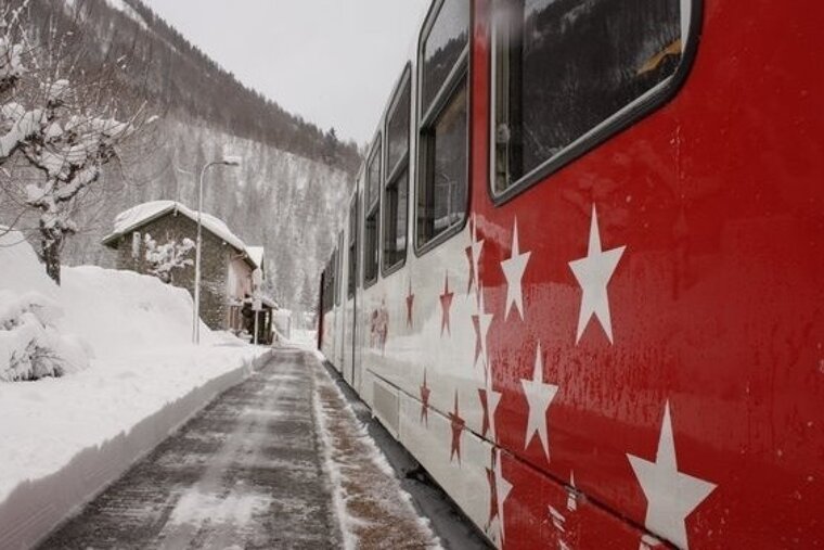 image of train stopped at snow covered station