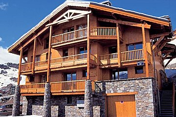 A large wooden building with a sign that says ' hotel ' on it
