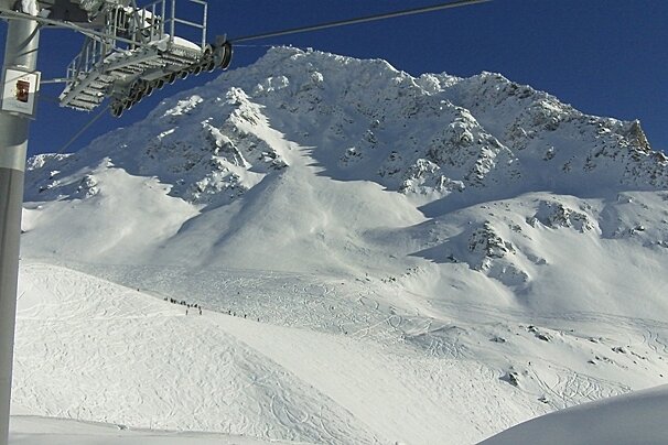 Ski lift and mountains and piste in distance