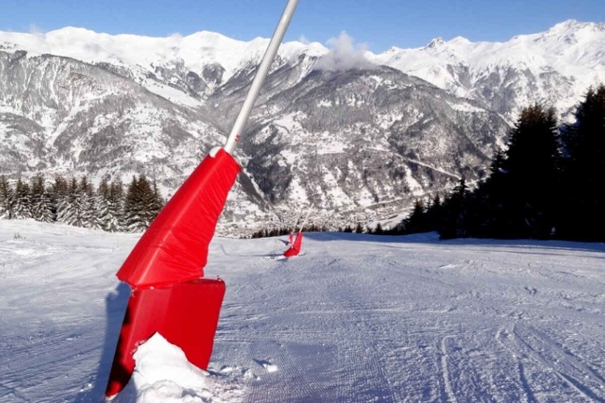 A ski slope with mountains in the background