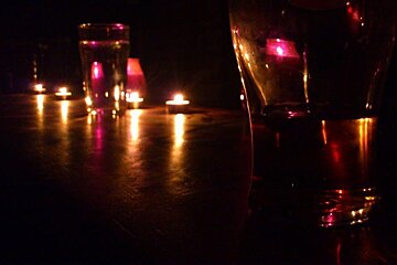 An image of candles and beer glasses on a bar during a blackout in Chamonix Mont Blanc