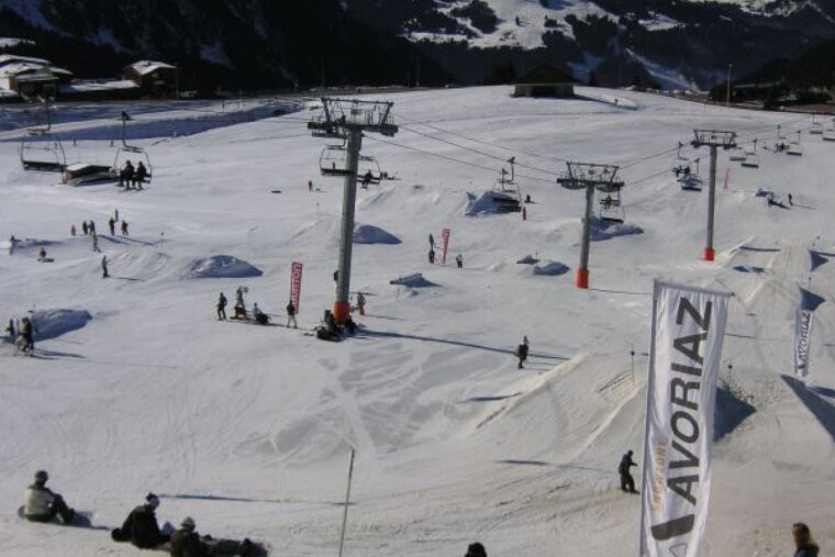 A snowy ski slope with a banner that says avoriaz