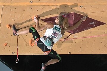 A female climber is wearing a shirt that says usa on it