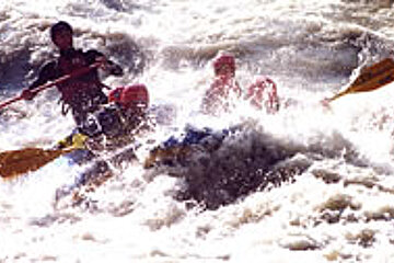 A group of people are rafting down a river