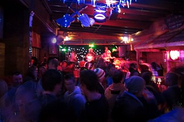 Group playing in a bar with crowd in the foreground