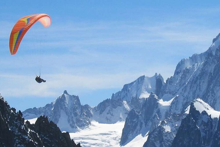 An image of a paraglider over mountains, Fly Chamonix