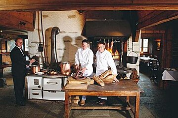 a picture of a team of people stood next to a table with some bread on