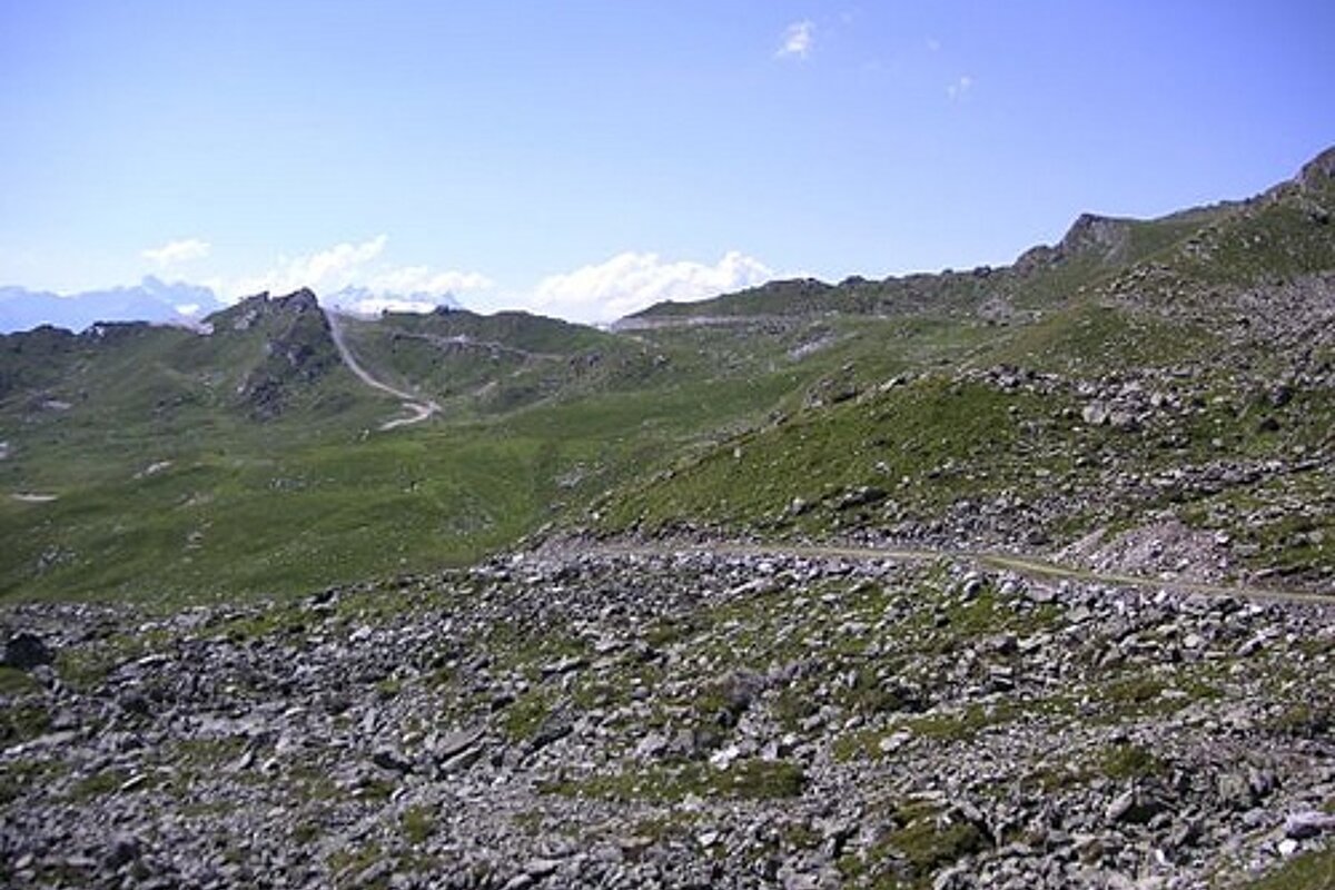 A rocky hillside with a road going through it