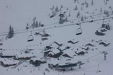 An aerial view of a ski resort covered in snow with ski lifts