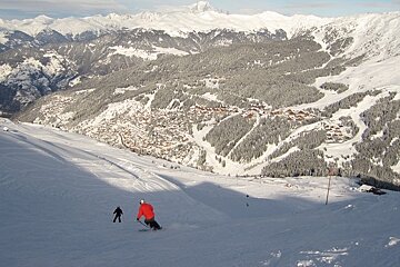 skiers above snowy meribel