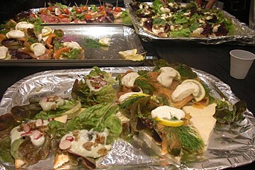 Several trays of food are sitting on a table