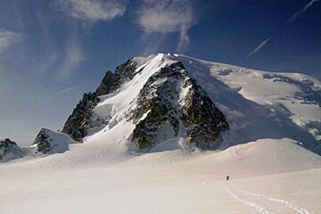 A person is walking up a snow covered mountain