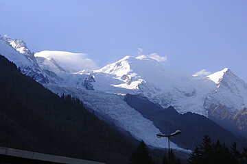 A snowy mountain with a street light in the foreground