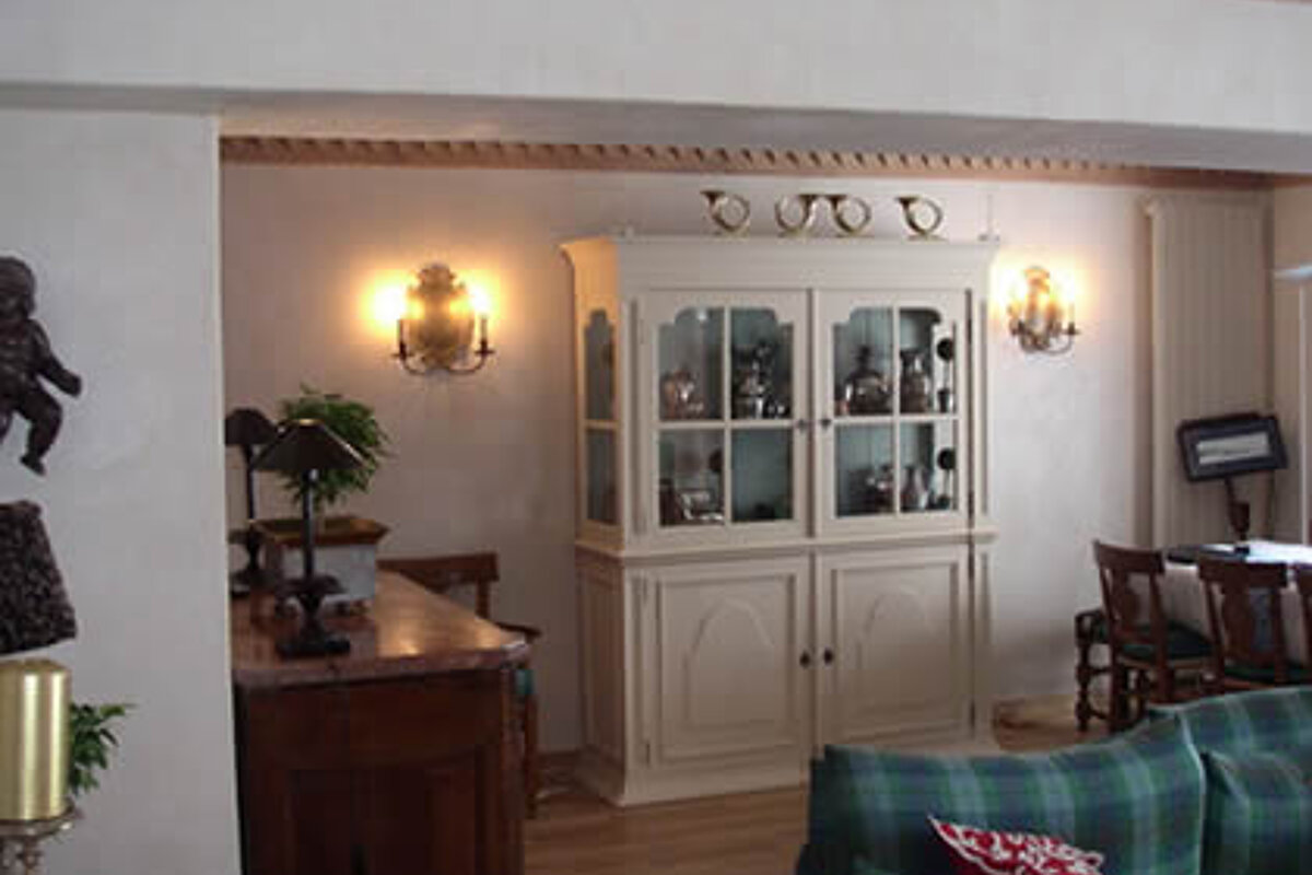 A living room with a hutch and a couch