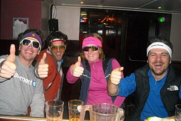 A man wearing a headband that says decathlon gives a thumbs up
