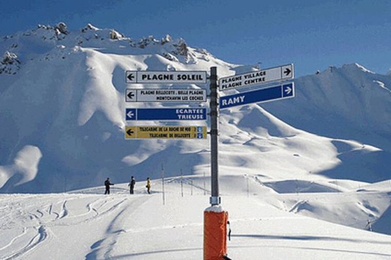 A snowy mountain with a sign that says ramy on it