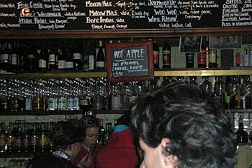 A bar with a sign that says hot apple on it