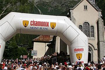 A crowd of people are gathered in front of a church