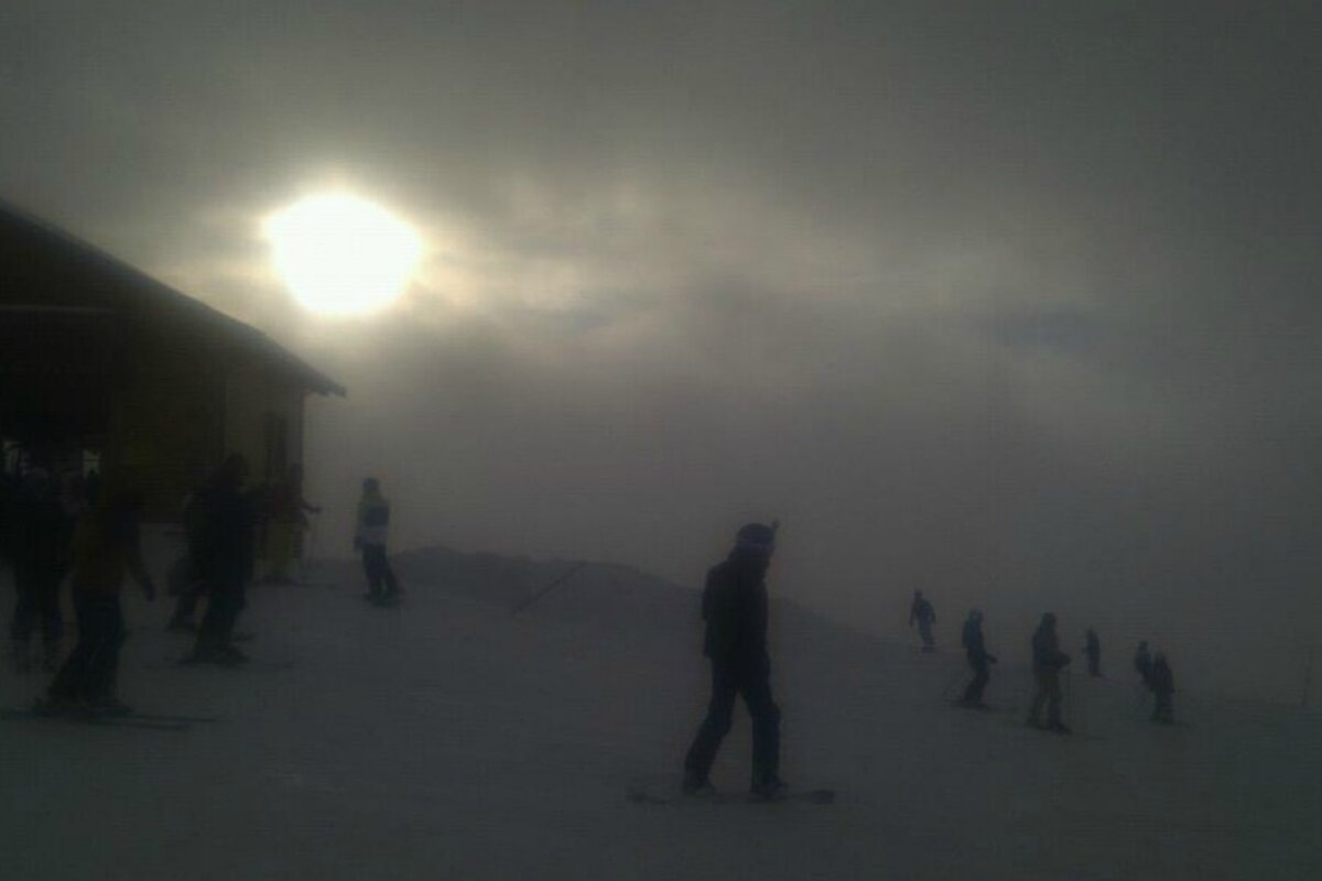 An image of snowboarders and skiers chasing the fleeting suinshine
