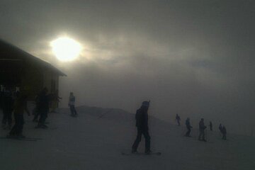 An image of snowboarders and skiers chasing the fleeting suinshine