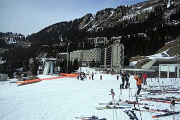 A group of people skiing down a snow covered slope
